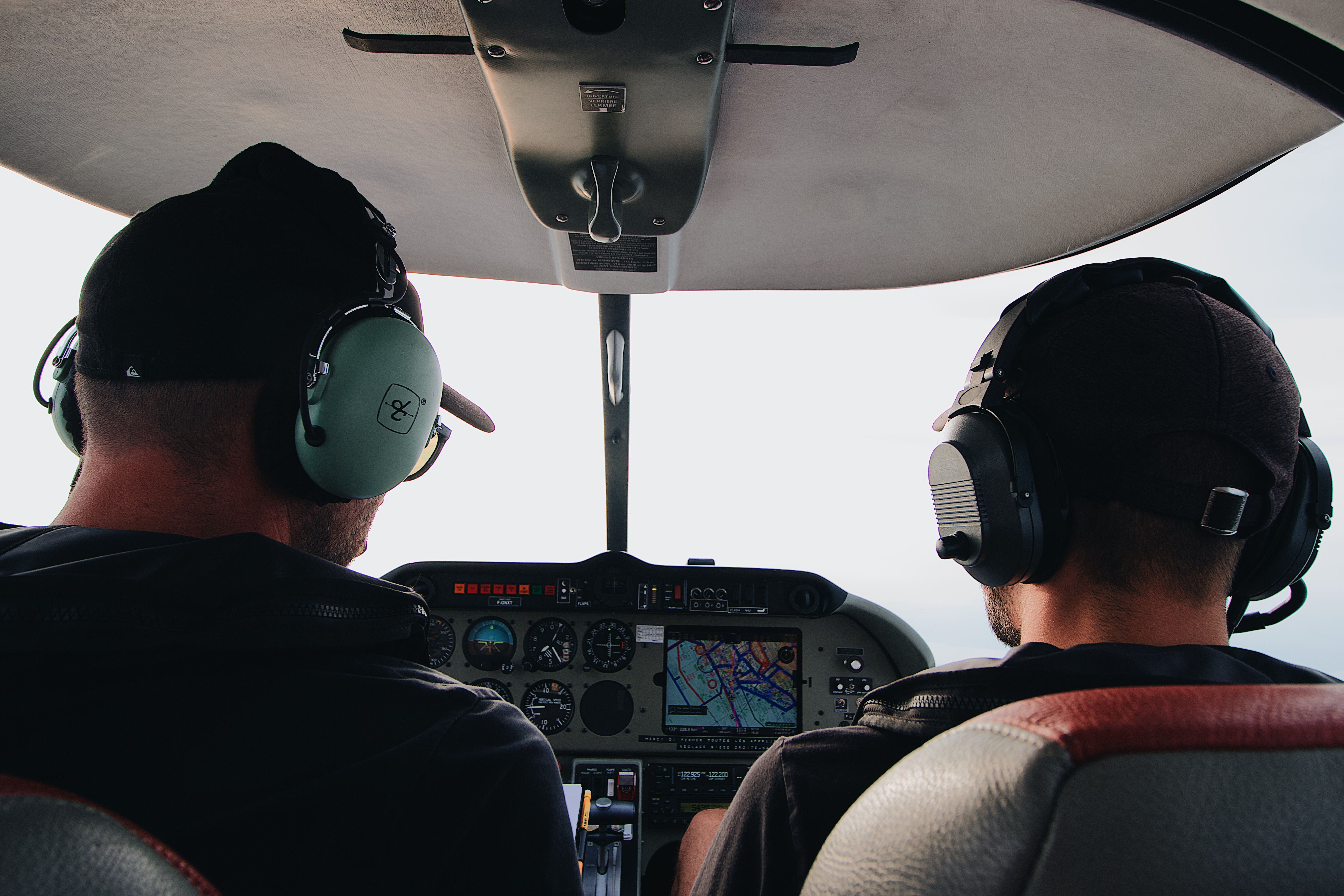 Two pilots flying with a moving-map navigation screen in the cockpit